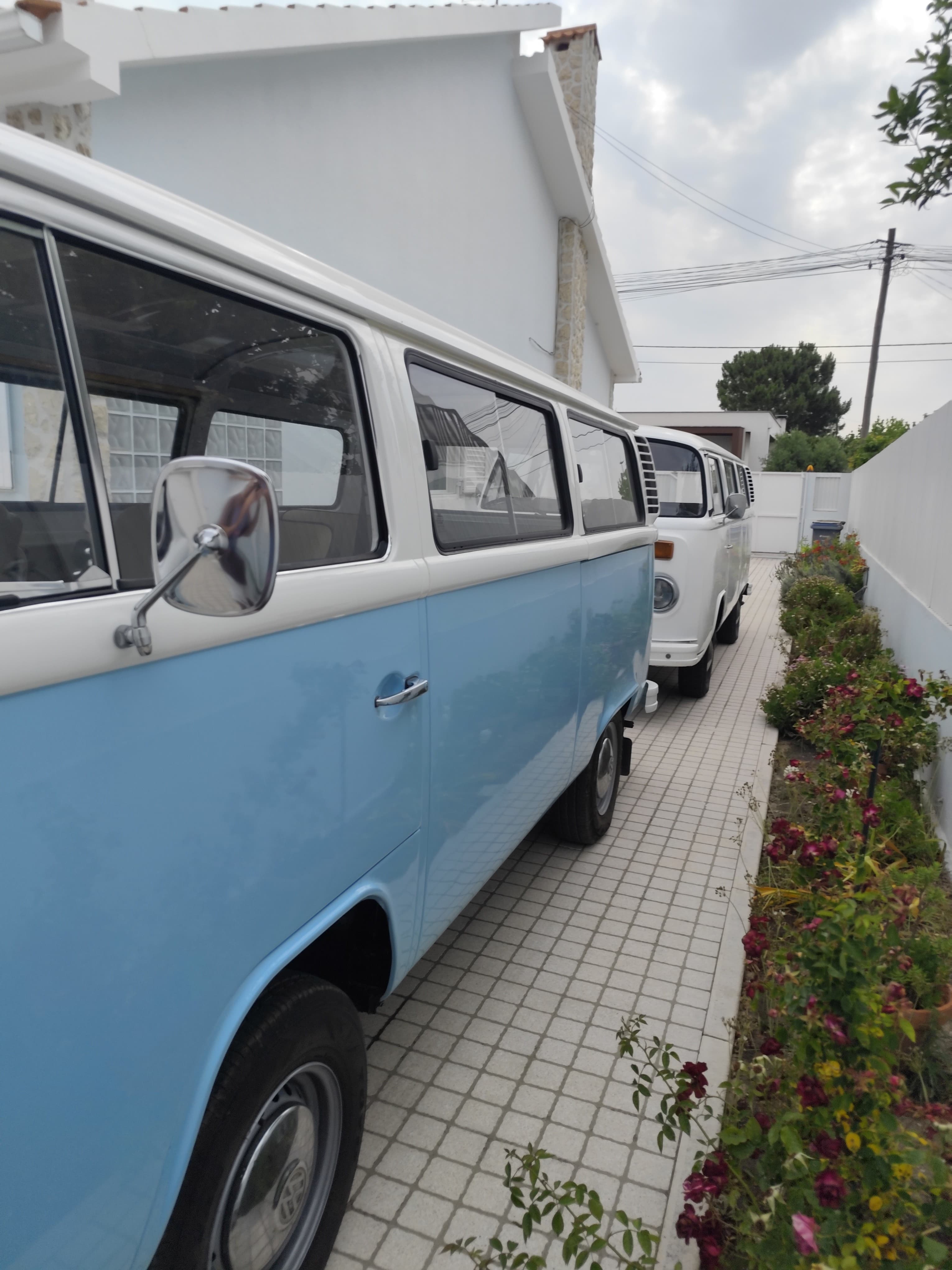 As duas vans de perfil à entrada da garagem